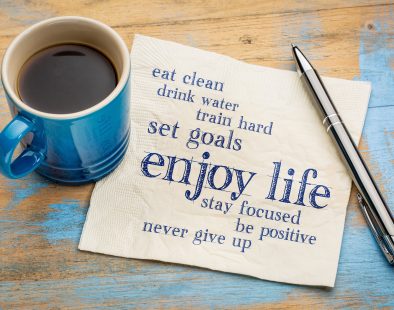enjoy life - healthy lifestyle word cloud on a napkin with a cup of coffee